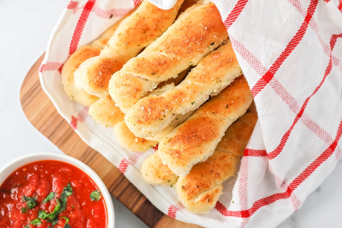 Homemade breadsticks served with marinara.