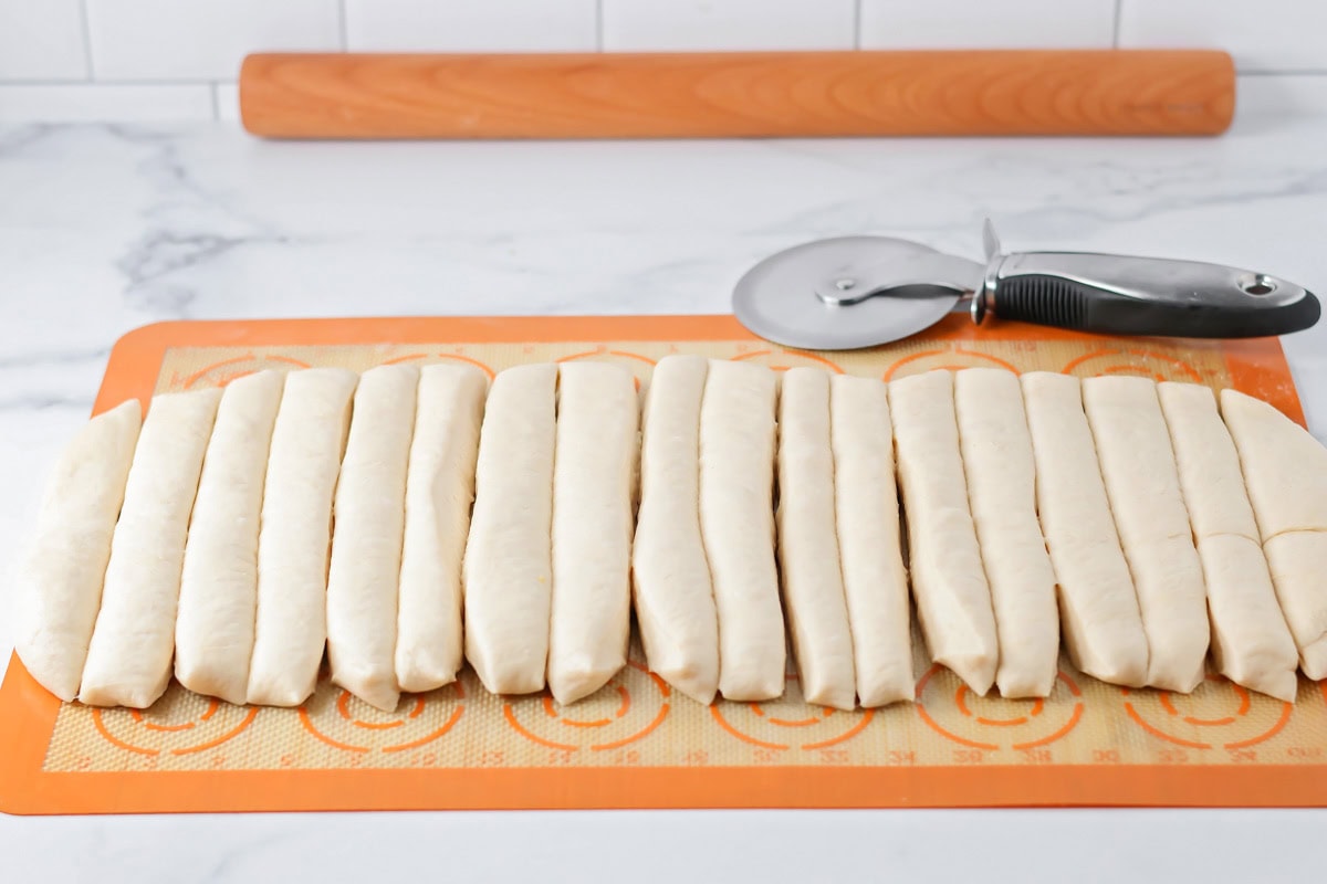 Dough cut into strips for making homemade breadsticks.