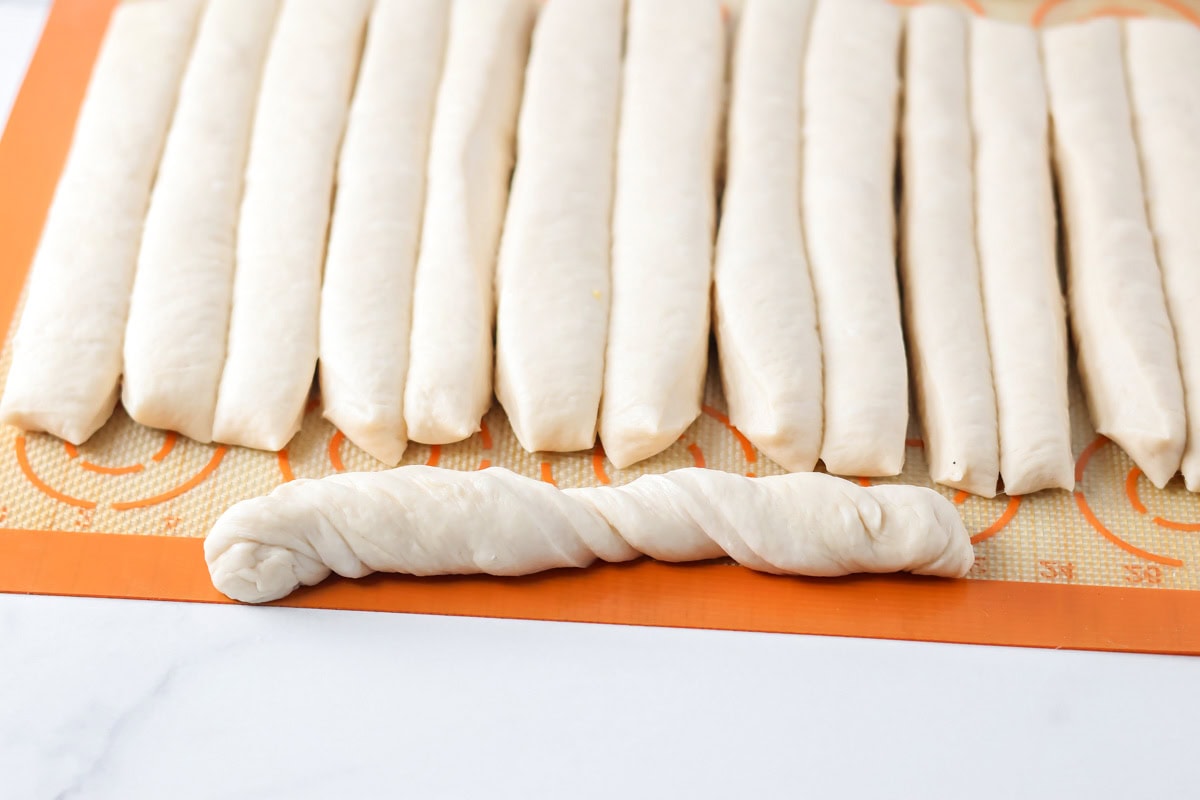 Sliced breadsticks on a silpat mat.