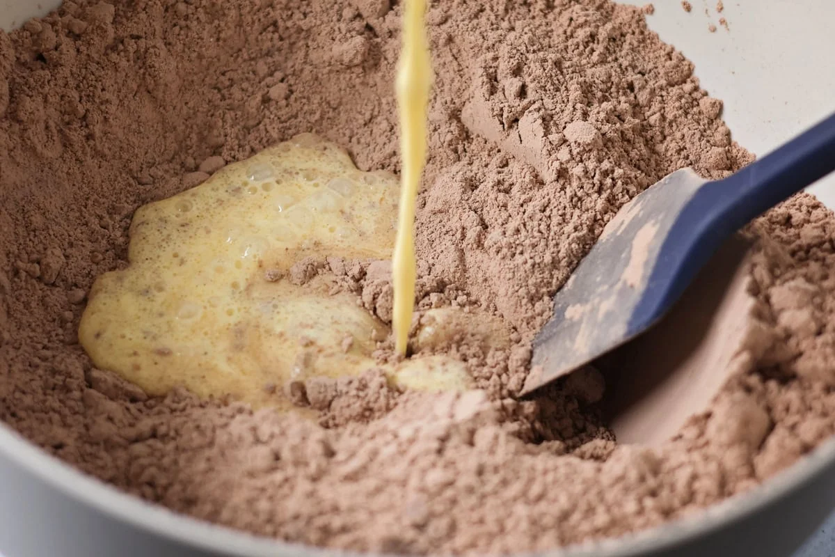 Brownie cake made from cake mix poured into bowl.