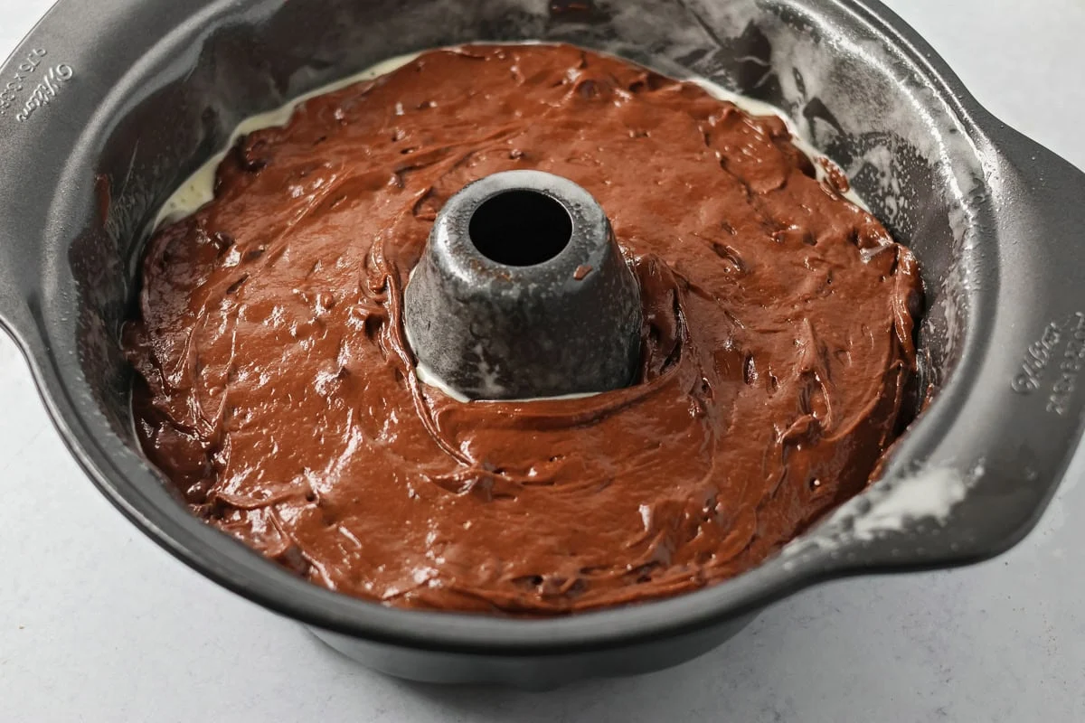 Brownie cake poured into bundt pan.