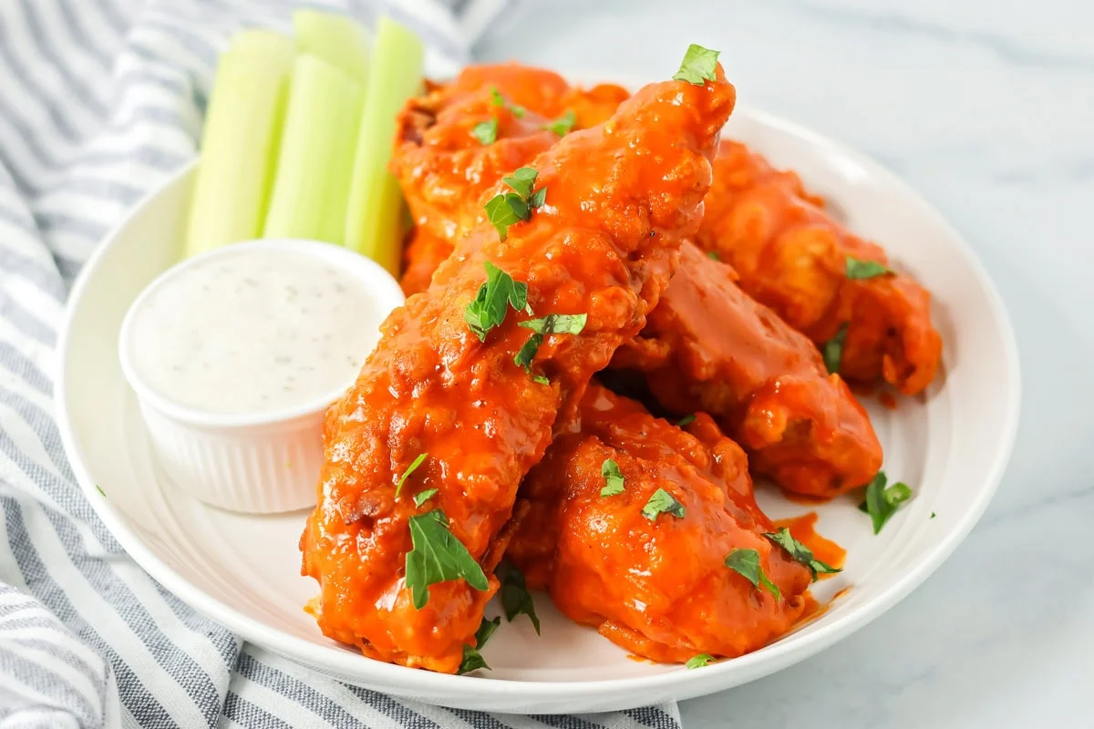 Buffalo chicken tenders served with dipping sauce.