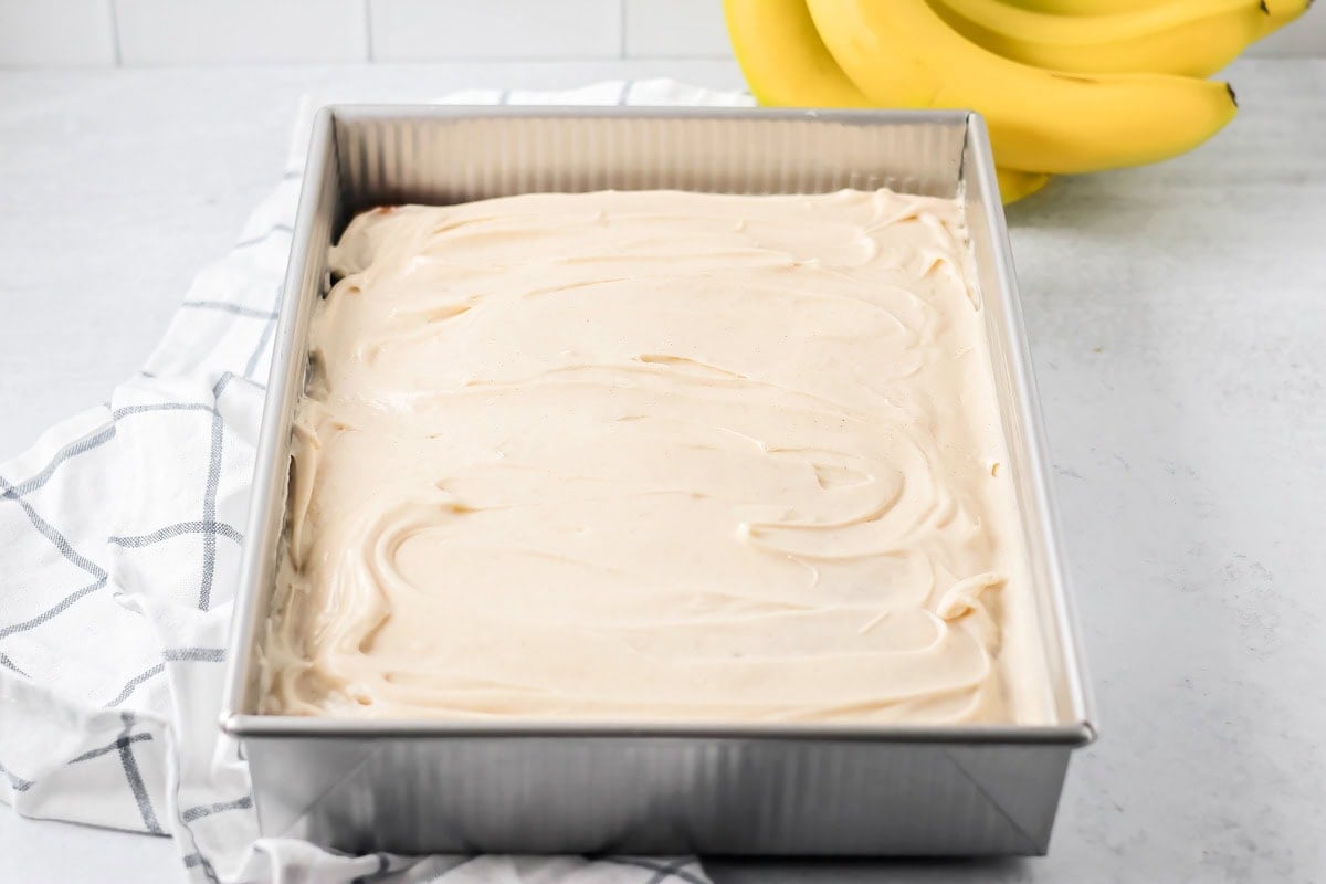A baking pan of frosted banana cake.