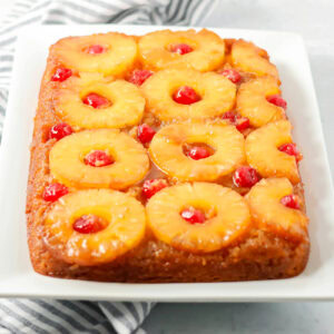 An easy pineapple upside down cake on a white platter.