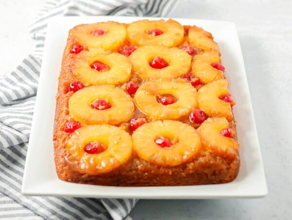 An easy pineapple upside down cake on a white platter.
