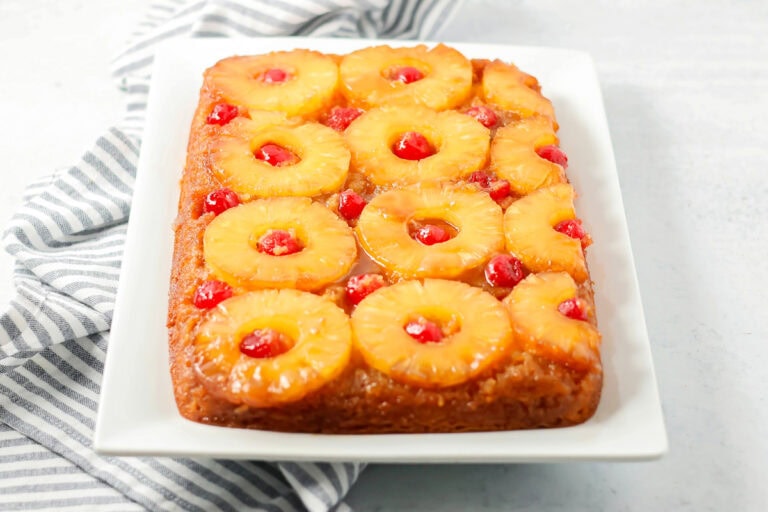 An easy pineapple upside down cake on a white platter.