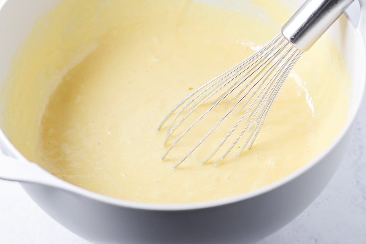 Cake batter mixed in a white bowl.