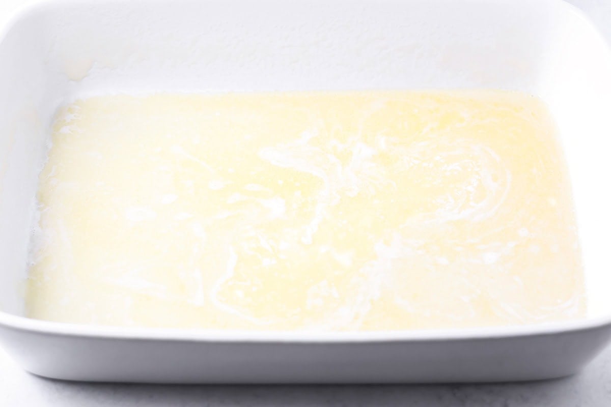 Melted butter at the bottom of a baking dish.