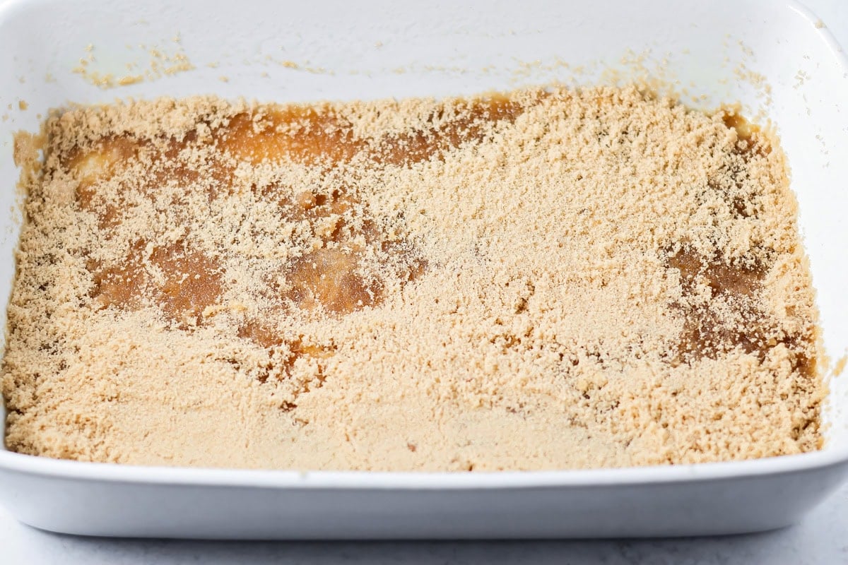 Brown sugar spread on the bottom of a baking dish.