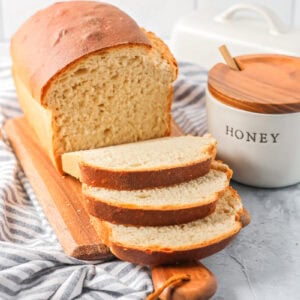 Sliced honey bread on a cutting bread.