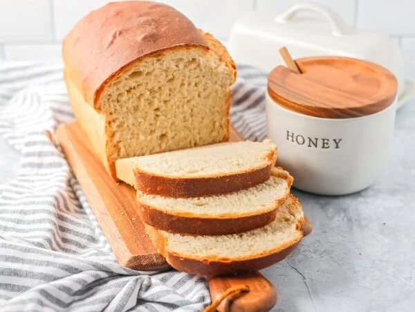 Sliced honey bread on a cutting bread.