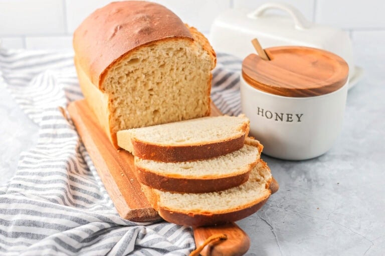 Sliced honey bread on a cutting bread.