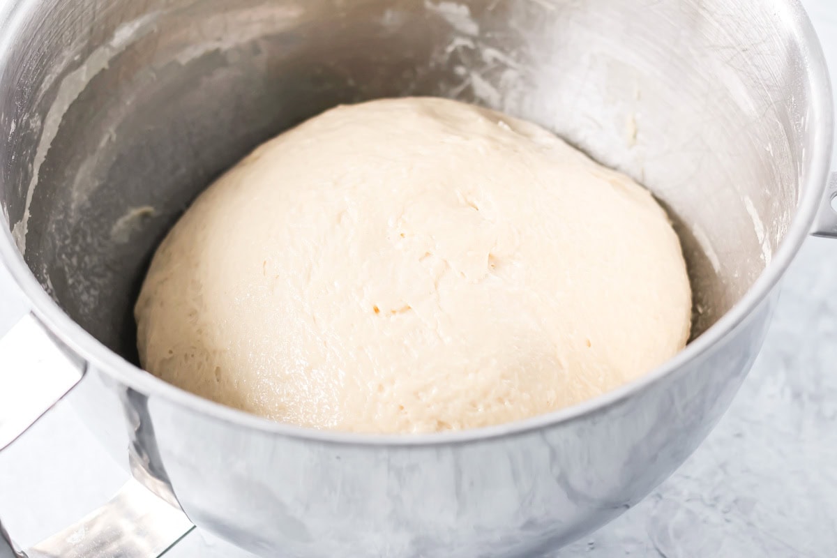Bread dough in a metal bowl.