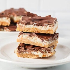 Three cut mounds bar recipe stacked on a white plate.