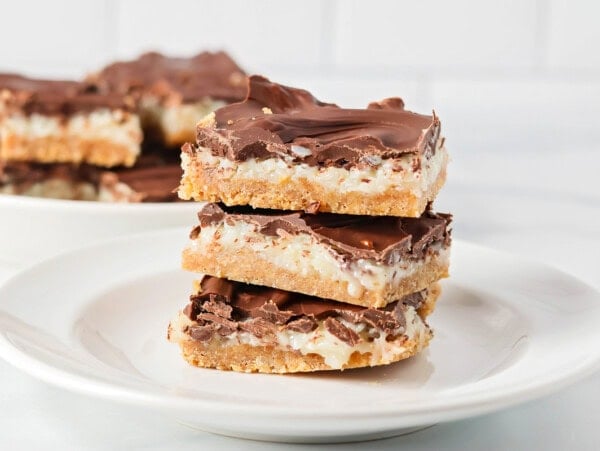 Three cut mounds bar recipe stacked on a white plate.