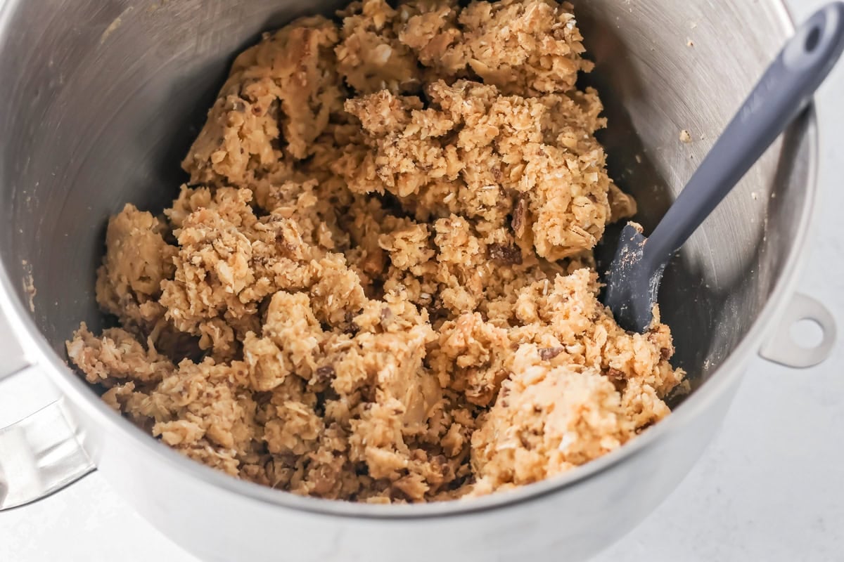 Oatmeal toffee cookie batter in a mixing bowl.