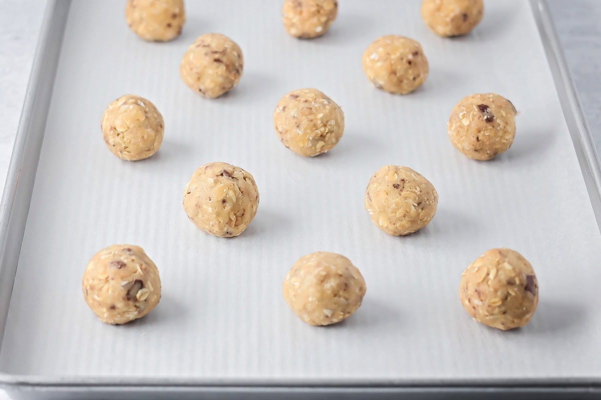 Oatmeal toffee cookie balls on a baking sheet.