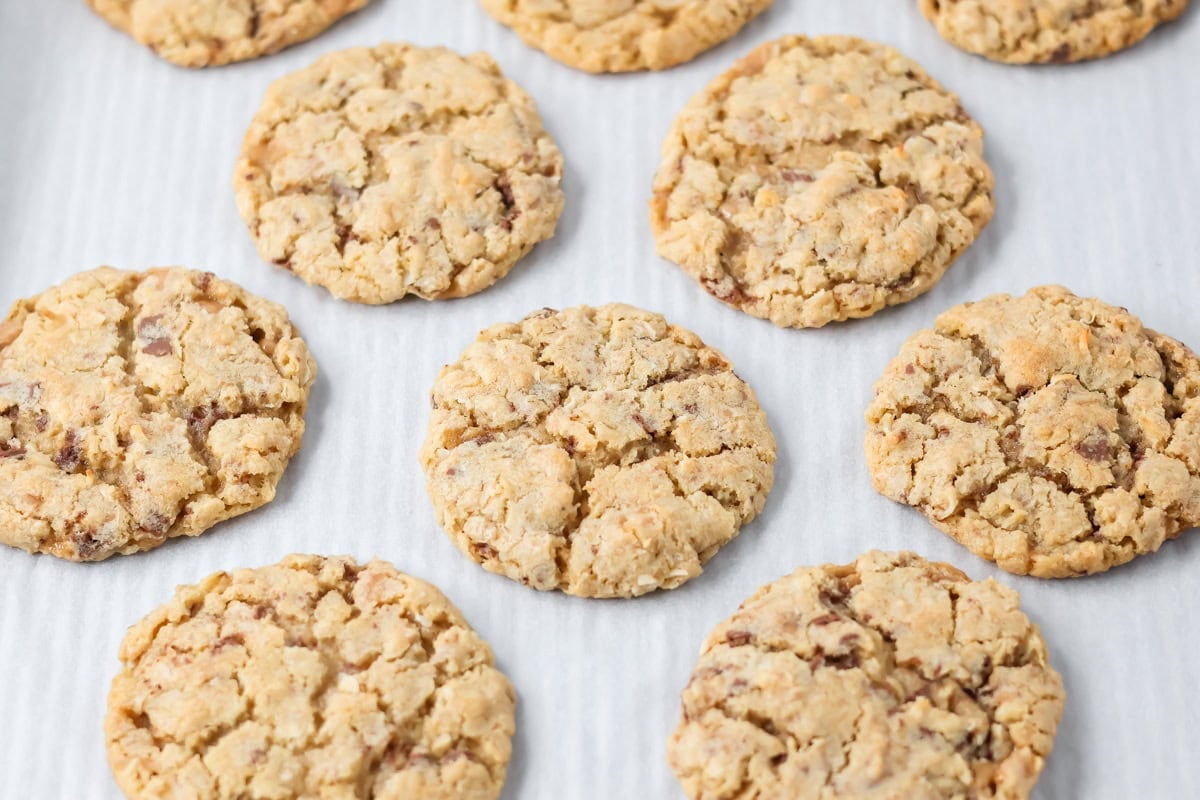 Several oatmeal toffee cookies on parchment paper.