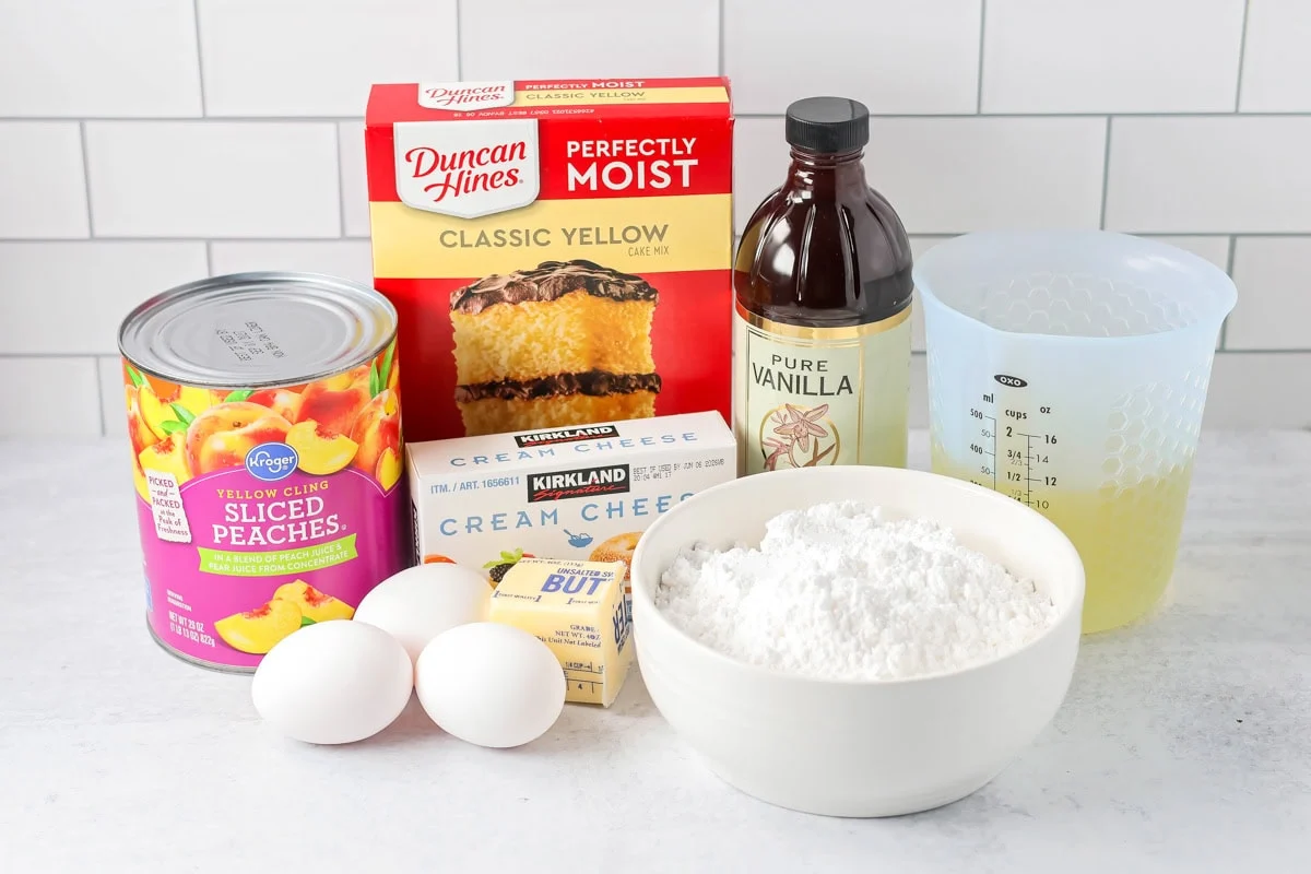 Peaches and cream cake ingredients on counter.