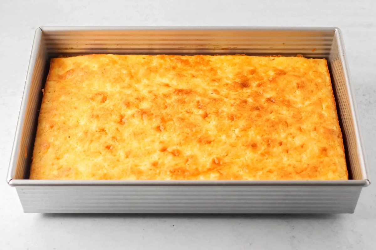 A baked pineapple cake in a baking pan.