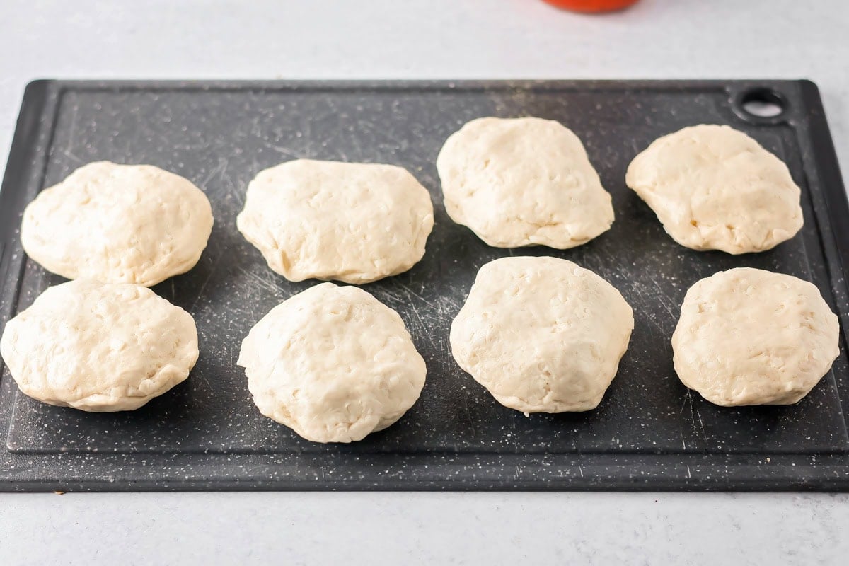 Pizza waffle dough balls on a cutting board.