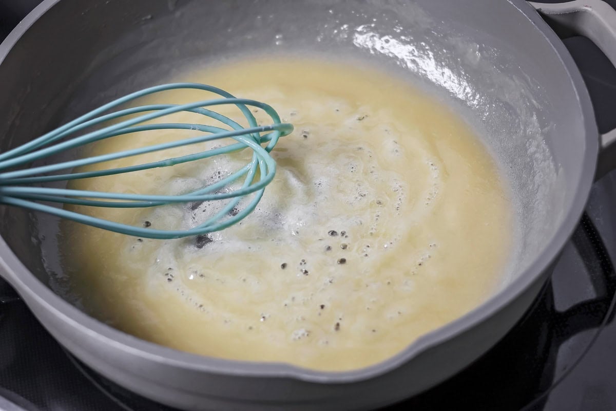 A roux cooking in a pan for poutine gravy.
