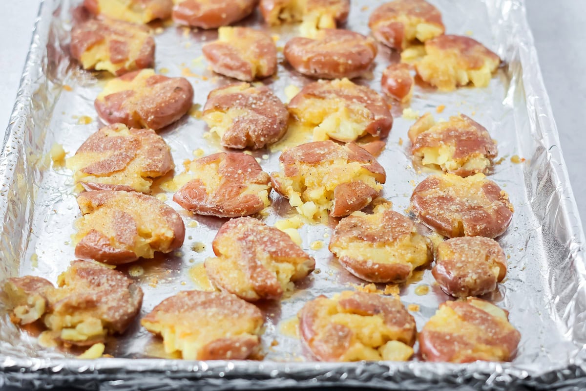 Smashed potatoes on foil lined cookie sheet.