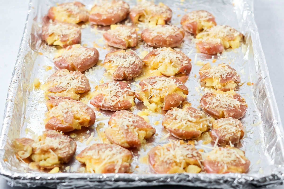 Smashed potatoes sprinkled with Parmesan cheese.