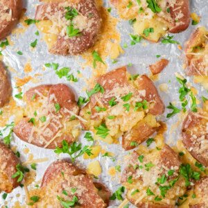 Smashed potatoes baked crispy on foil lined baking sheet.