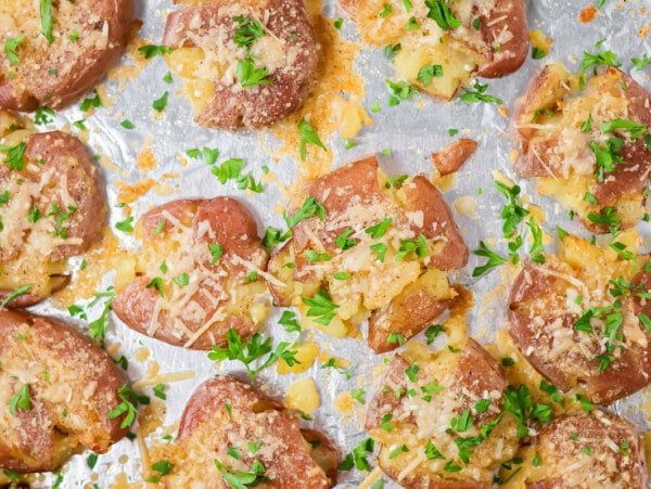 Smashed potatoes baked crispy on foil lined baking sheet.