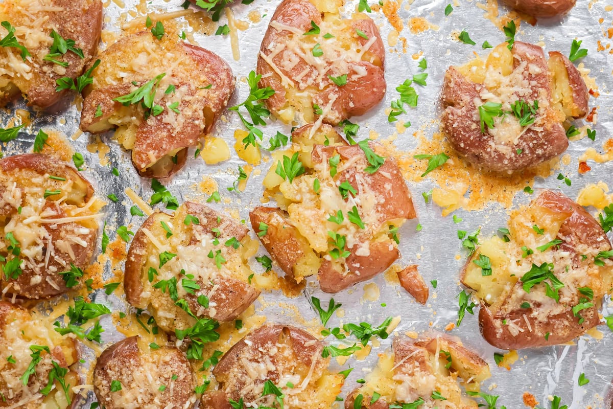 Crispy smashed potatoes recipe baked on foiled lined baking sheet.