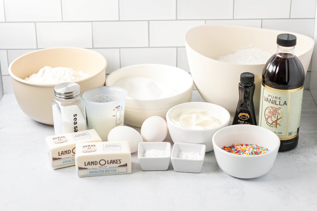Ingredients for sugar cookie cake on a kitchen counter.