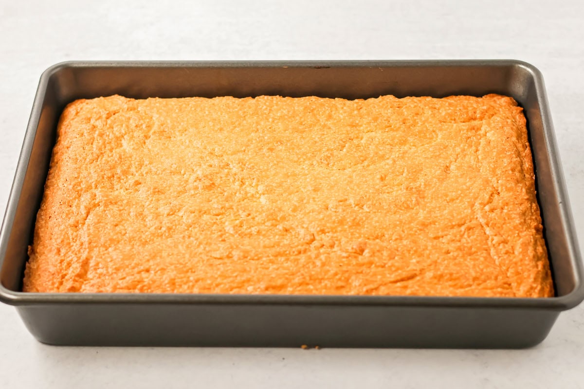 A sugar cookie cake baked in a metal dish.