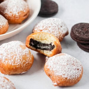 Fried Oreos with bite taken out with Oreos on the side.