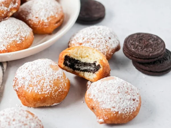 Fried Oreos with bite taken out with Oreos on the side.