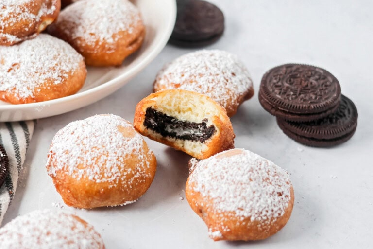 Fried Oreos with bite taken out with Oreos on the side.