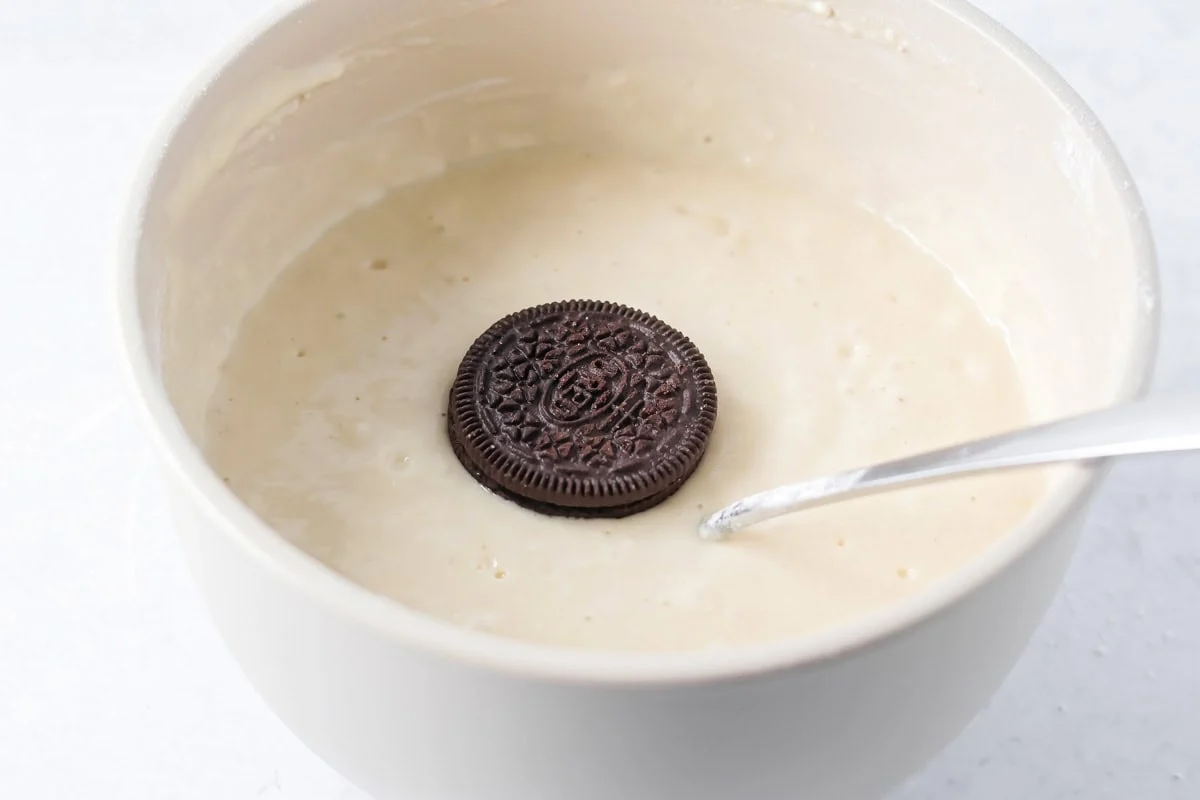 Dipping Oreos in pancake batter.
