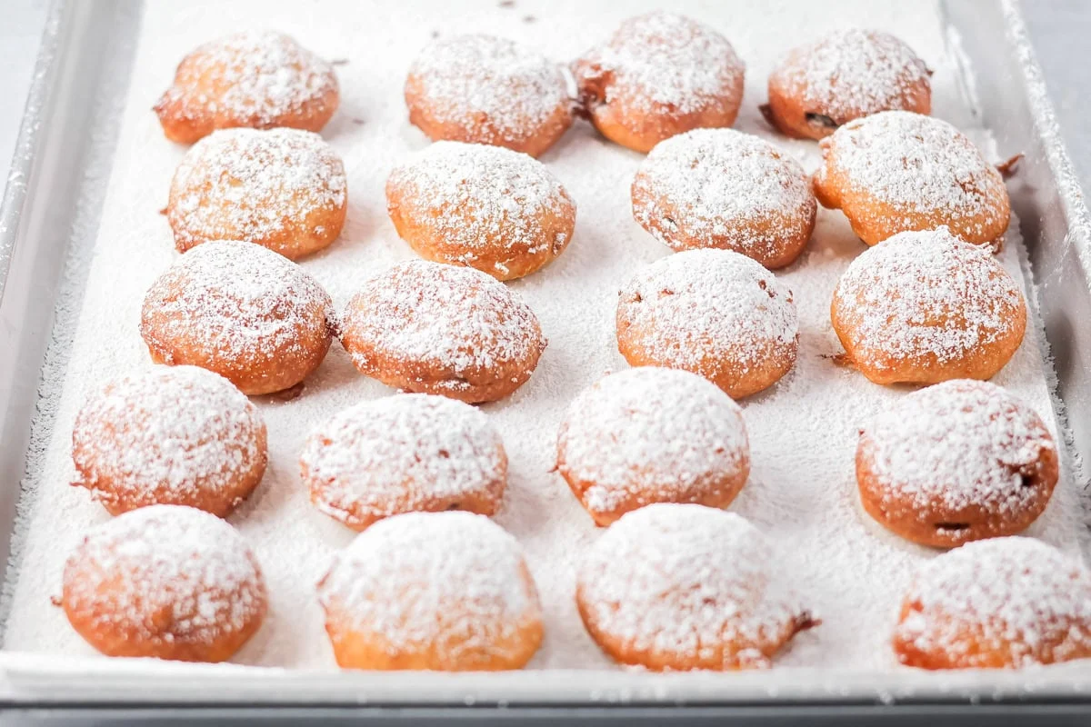 Fried Oreos being dusted in powdered sugar.