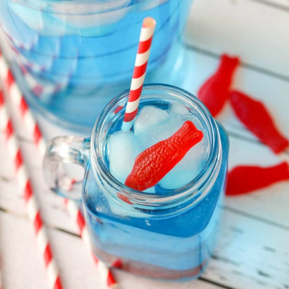 Fizzy coconut Ocean Water is easy and refreshing! This copycat Sonic drink is perfect for parties or a hot, summer day. Ocean water served in a glass mason jar with candy fish.