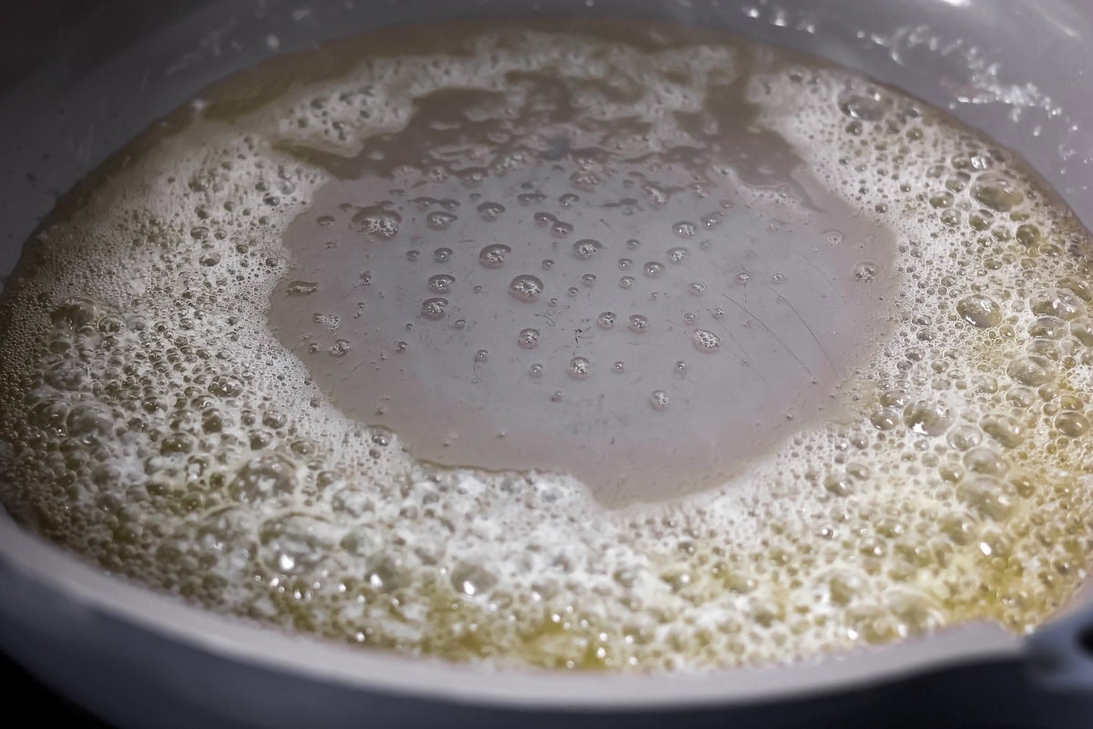Melting butter in a pan on the stove for baked mac an cheese.