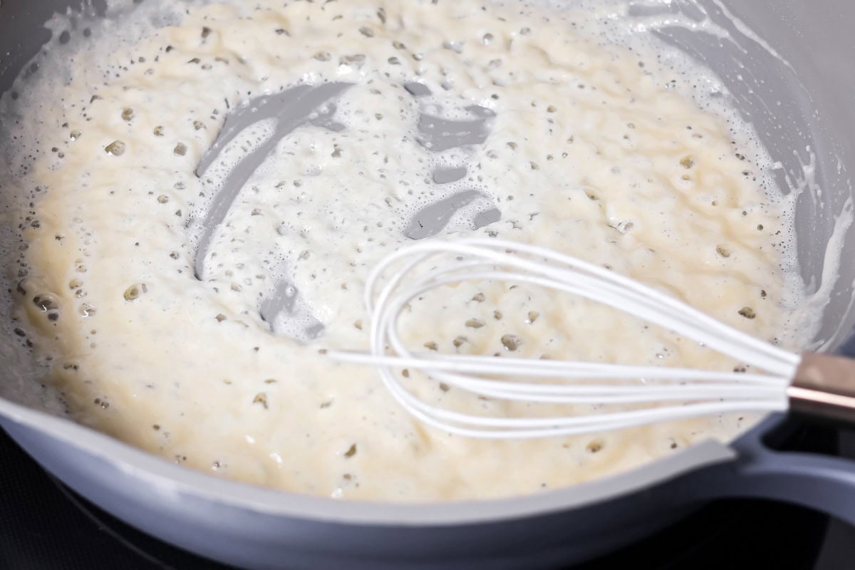Making a roux for baked mac and cheese in a pan.