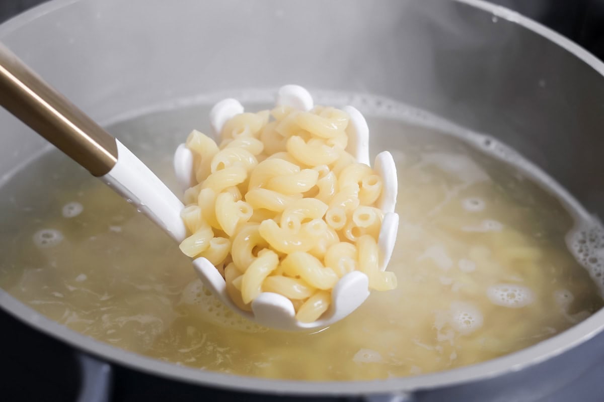 A pot of cooked pasta for baked mac and cheese.