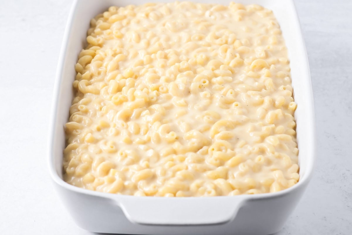 Baked mac and cheese mixture spread in a baking dish.