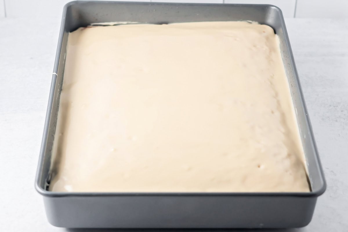 Glazed buttermilk cake in a baking dish.