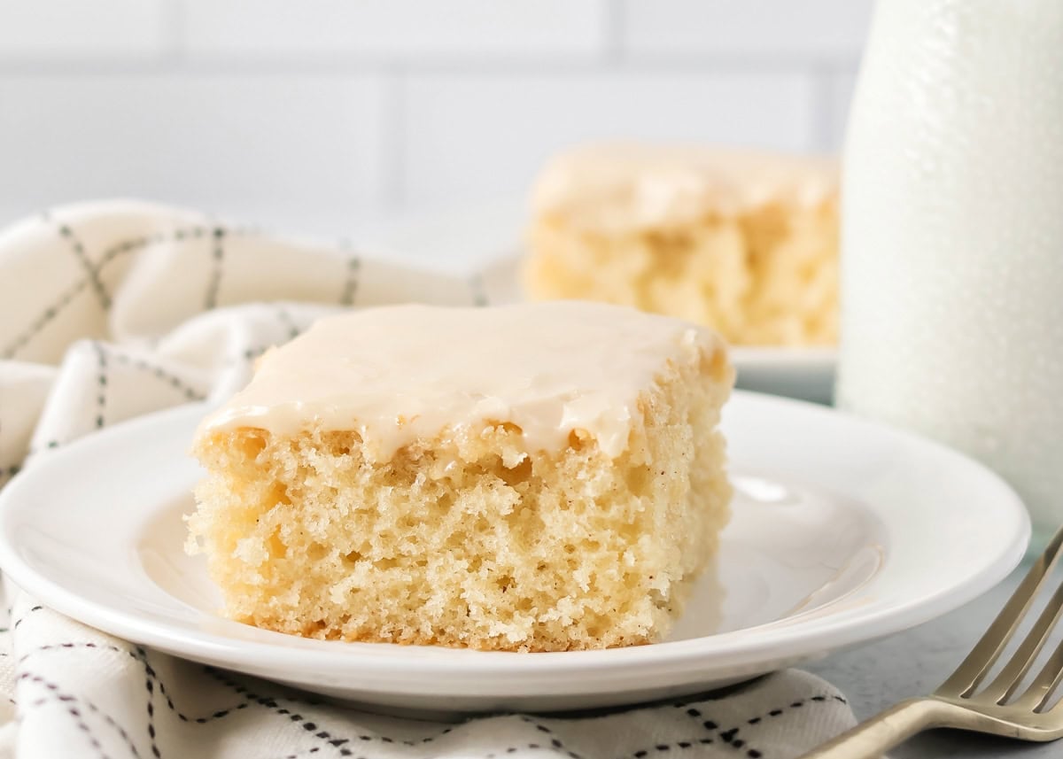 A slice of buttermilk cake topped with glaze.