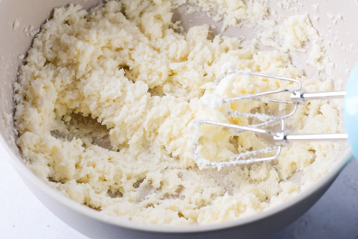 Whisking ingredients for buttermilk cake in a bowl.
