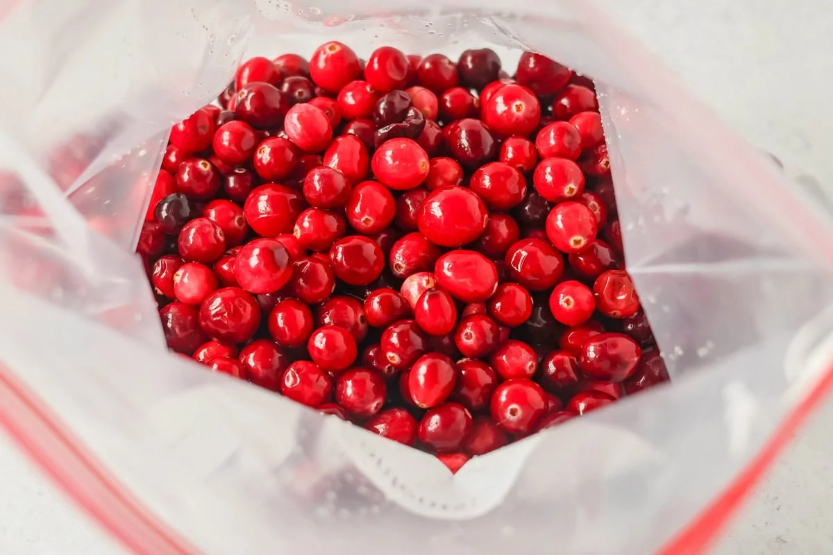 A ziploc bag of cranberries soaking in sprite for candied cranberries.