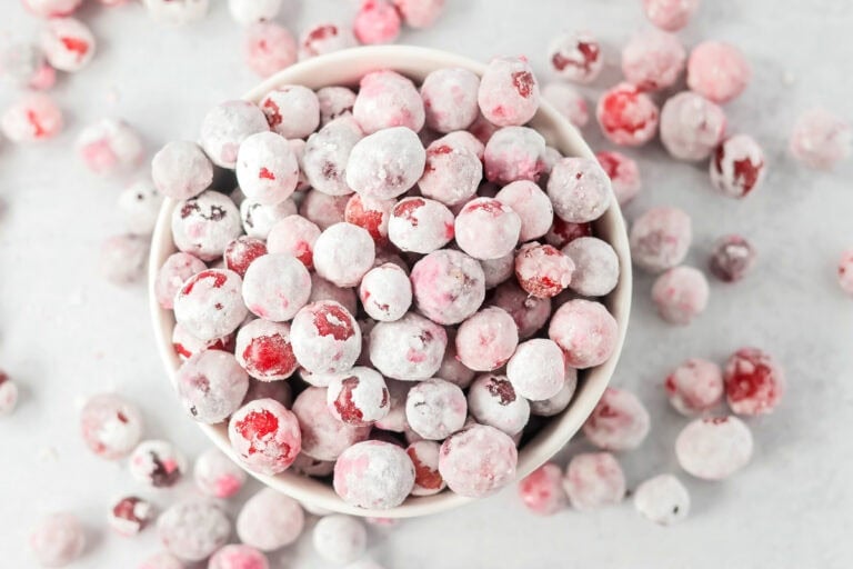 Candied cranberries in a white bowl.