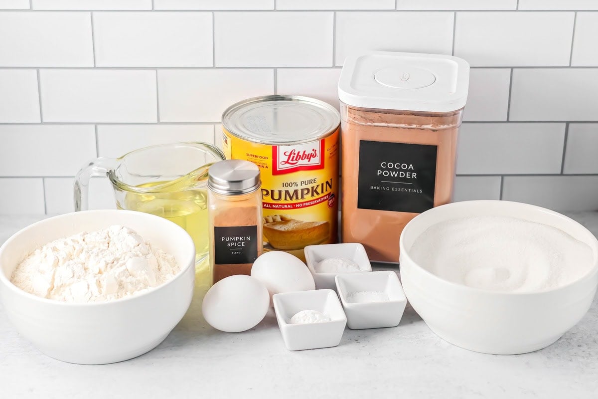 Chocolate pumpkin cake ingredients on a kitchen counter.