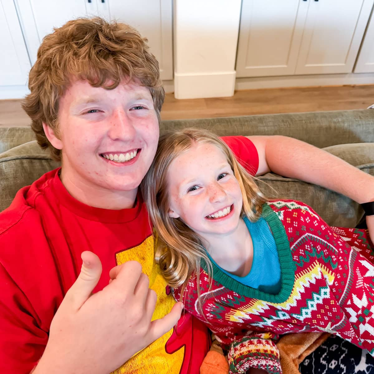 The siblings share a hug after exchanging gifts for Christmas in July.